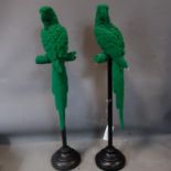 A pair of green parrots perched on stands, H.91cm