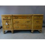 A Victorian pine chest/dresser base with 9 drawers, raised on turned feet, H.83 W.174 D.50cm