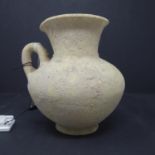 An Assyrian jug with bell shaped neck, possibly 500 bc, H.18cm
