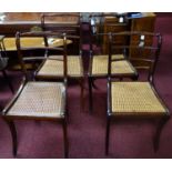 A set of 6 mahogany chairs, with carved crest rails and backrests, having caned seats, on sabre legs