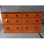 A Victorian pine chest/dresser base with 6 drawers, painted orange, H.93 W.166 D.64cm