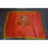 A large Soviet theatrical embroidered silk banner, with hammer and sickle to obverse and bust of