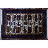 A 20th century Afghan 'military' Belouch rug, with geometric vehicle motifs, on a beige ground,