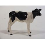 A BESWICK FRIESIAN CALF FIGURE