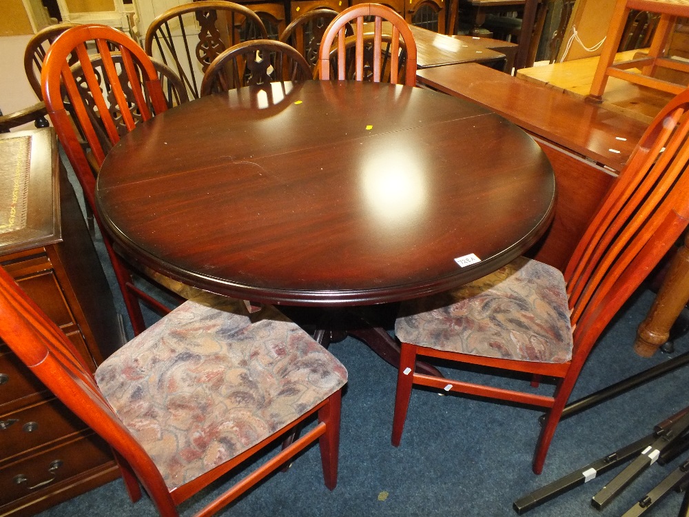 A MODERN CIRCULAR TABLE AND FOUR CHAIRS