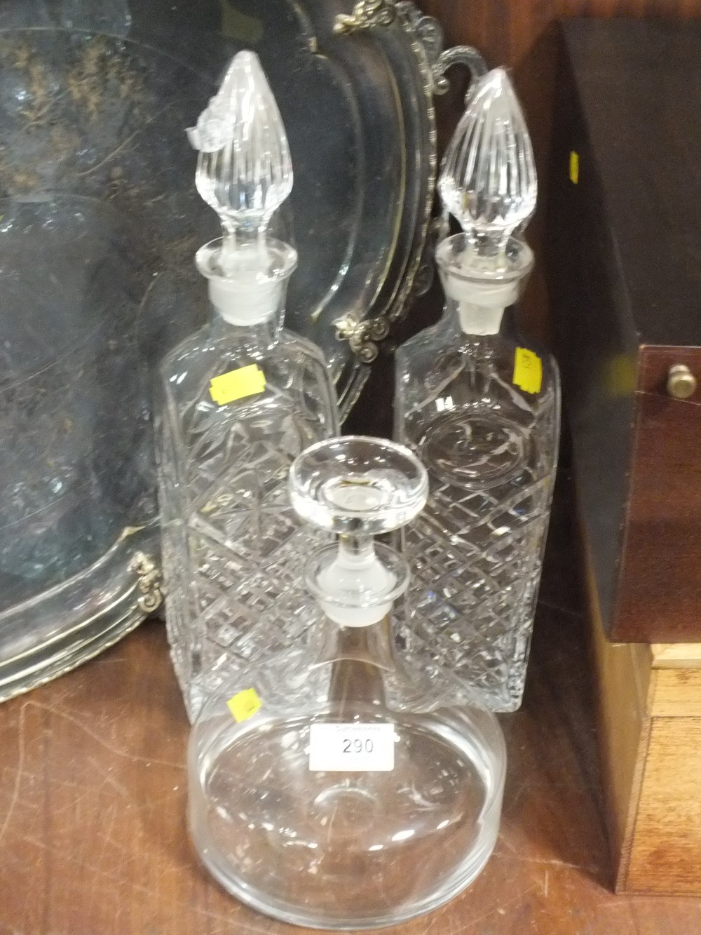 A PAIR OF CUT GLASS DECANTERS TOGETHER WITH ANOTHER