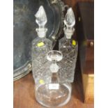 A PAIR OF CUT GLASS DECANTERS TOGETHER WITH ANOTHER