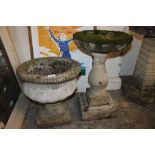 A STONE PLANTER ON PLINTH TOGETHER WITH A BIRDBATH ON PLINTH