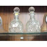 A PAIR OF VINTAGE HEAVILY CUT GLASS DECANTERS