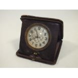 A VINTAGE LEATHER CASED 8 DAY TRAVEL CLOCK