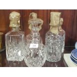 FIVE ASSORTED CUT GLASS DECANTERS