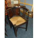 AN ANTIQUE OAK WICKER SEAT CORNER CHAIR