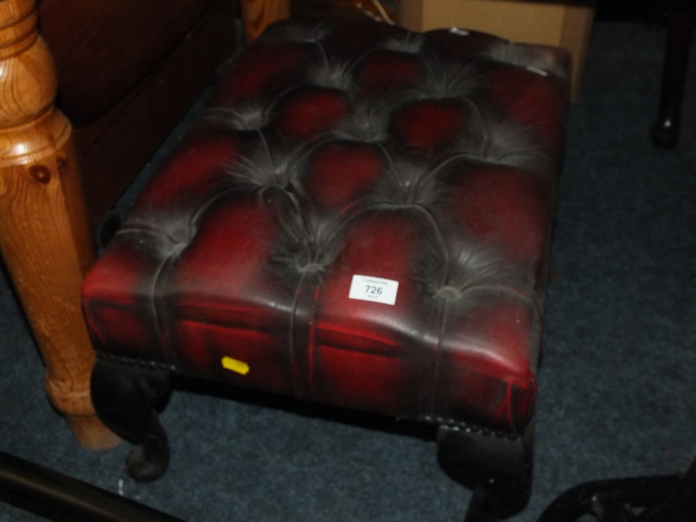 AN OXBLOOD LEATHER FOOTSTOOL