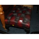 AN OXBLOOD LEATHER FOOTSTOOL