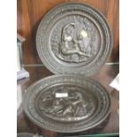 A PAIR OF CAST METAL BRONZE EFFECT WALL HANGING PLAQUES