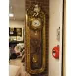 A TALL SLENDER ORNATE WALL MOUNTED FRENCH STYLE CLOCK WITH GILT AND CHERUBIC DECORATION, 31 DAY