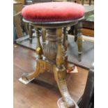 A LATE VICTORIAN CARVED REVOLVING PIANO STOOL