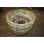 A STONE GARDEN PLANTER WITH BARREL AND IVY LEAF EFFECT