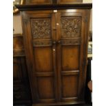 A QUALITY REPRODUCTION CARVED OAK DOUBLE GENTLEMANS WARDROBE H 168 W 100 CM AND A HEADBOARD (2)