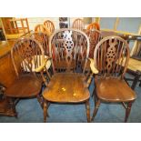 A SET OF SIX OAK WHEELBACK CHAIRS TO INCLUDE ONE CARVER