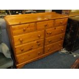 A MODERN HONEY PINE NINE DRAWER CHEST H 100 W 133 CM