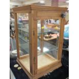A MODERN PINE AND GLASS THREE TIERED TABLE TOP DISPLAY CABINET
