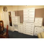 A LARGE QUANTITY OF MODERN WHITE BEDROOM FURNITURE TO INCLUDE THREE CHESTS, TRIPLE WARDROBE FITMENT,