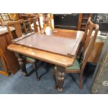 AN EDWARDIAN EXTENDING MAHOGANY DINING TABLE WITH ONE EXTRA LEAF AND FOUR CHAIRS