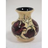 A SMALL MOORCROFT CHOCOLATE COSMOS PATTERN VASE