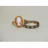 A YELLOW METAL CAMEO RING STAMPED 750 TOGETHER WITH AN ETERNITY RING SET WITH GREEN AND CLEAR STONES