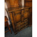 A QUALITY REPRODUCTION CARVED OAK CABINET ON CASTORS H 101 W 83 CM