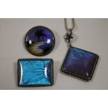 A SILVER AND BUTTERFLY WING PENDANT ON CHAIN AND TWO BROOCHES