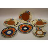 A SELECTION OF CLARICE CLIFF CROCUS PLATES AND SAUCERS TOGETHER WITH SOME JOHN GUILDFORD ARABESQUE