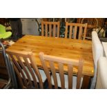 A MODERN PINE DINING TABLE AND FOUR CHAIRS