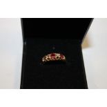 A HALLMARKED 18 CARAT GOLD RUBY AND DIAMOND RING