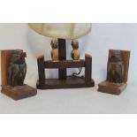A PAIR OF CARVED WOODEN BOOK ENDS MOUNTED WITH BIRDS, together with a similar table lamp