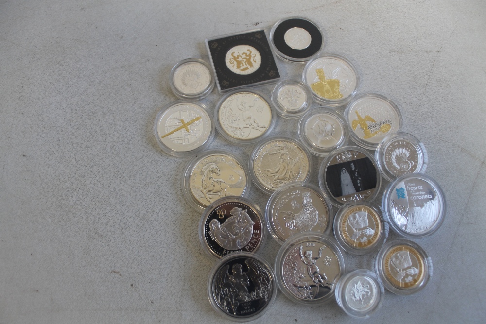 A QUANTITY OF SILVER PROOF COINS IN CAPSULES , to include £1 , £2, and £5 coins etc.