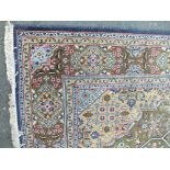 AN EASTERN STYLE WOOLLEN RUG / CARPET, with an all over pattern on a mainly green ground, 270 x