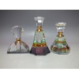 A SET OF THREE DECORATIVE MODERN GLASS PERFUME BOTTLES, varying styles and sizes, having lustre