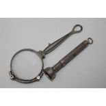 A HALLMARKED SILVER CIGAR PIERCER, together with a white metal press release lorgnette (2)