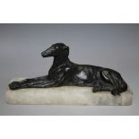 AN EARLY 20TH CENTURY TYPE FRENCH STYLE MODEL OF A DOG, lying on a marble plinth, W 20 cm