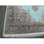 A LARGE EASTERN 20TH CENTURY WOOLLEN RUG, cream border with an all over pattern in shades of