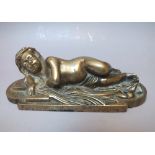 AN ANTIQUE ECCLESIASTICAL BRASS DESK WEIGHT IN THE FORM OF A CHILD ON A CROSS, W 15.5 cm