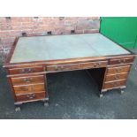 AN ANTIQUE MAHOGANY TWIN PEDESTAL PARTNERS DESK, the top with inset green leather writing surface,