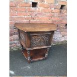 AN ANTIQUE STYLE OAK SINGLE DOOR CREDENCE TABLE / CABINET, with carved detail, raised on turned