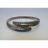 DAVID ANDERSON - A NORWEGIAN 925S STERLING BANGLE, of circular cross-over form decorated with