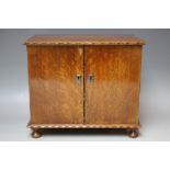 AN OAK CABINET RAISED ON FOUR FEET WITH FITTED INTERIOR, W 29.5 cm