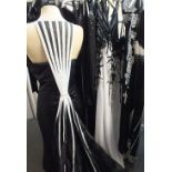A SELECTION OF LADIES EVENING WEAR, comprising mainly full length black / white dresses, most having