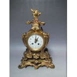 AN ORNATE FRENCH STYLE GILT MANTLE CLOCK, circular enamel face with Arabic numerals, 8 day