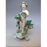 AN 18TH CENTURY DERBY PORCELAIN FIGURE, the cherubic figure amongst flowers with a floral sash,